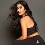 Katrina poses in a PPE kit outfit at the airport