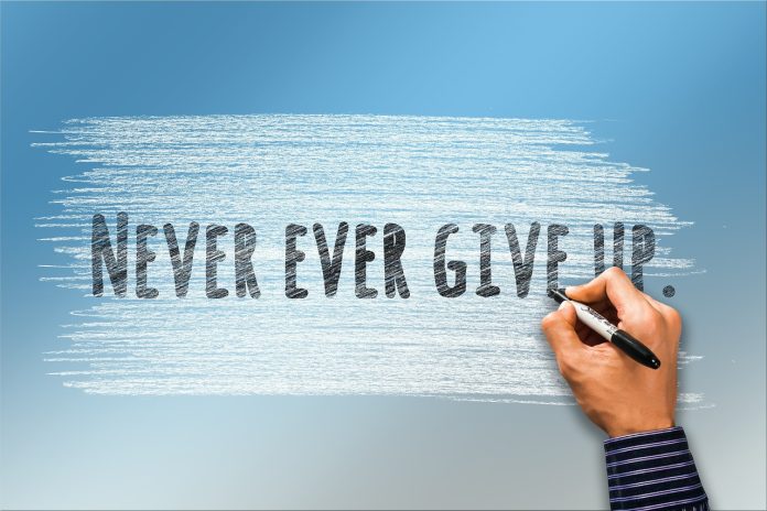 never give up written