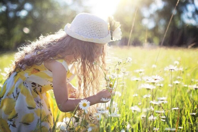 girl looking at flowers