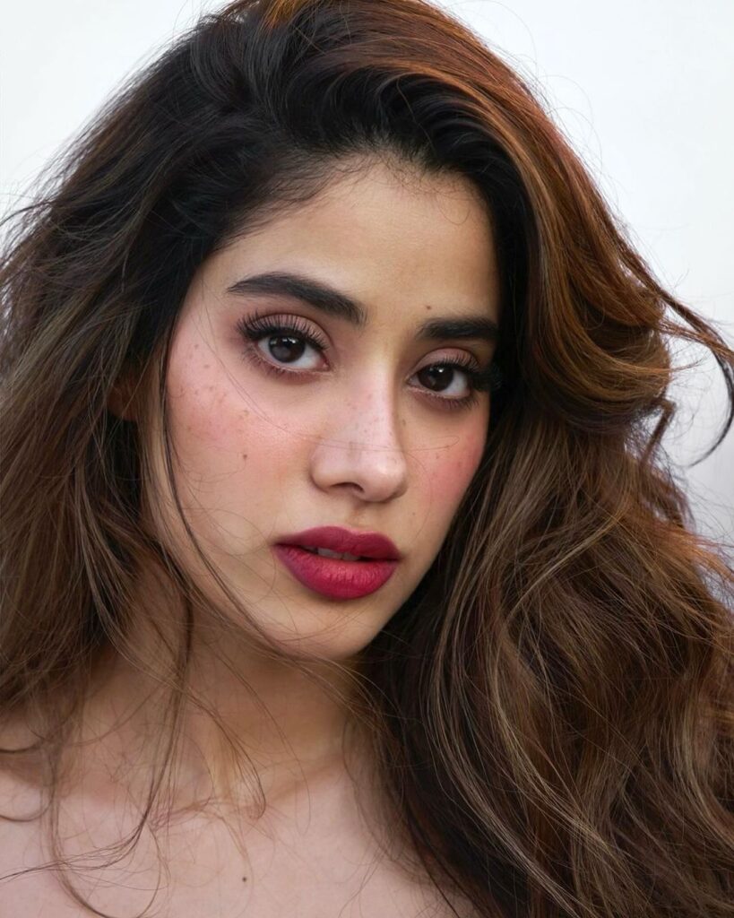 Janhvi Kapoor looking stunning in a dazzling red dress, capturing her elegant style.