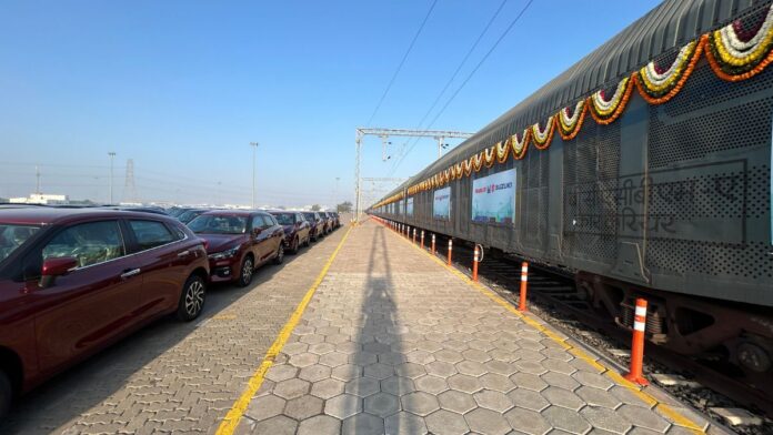 Prime Minister Modi inaugurating the revolutionary rail project at Suzuki's manufacturing plant in Gujarat.